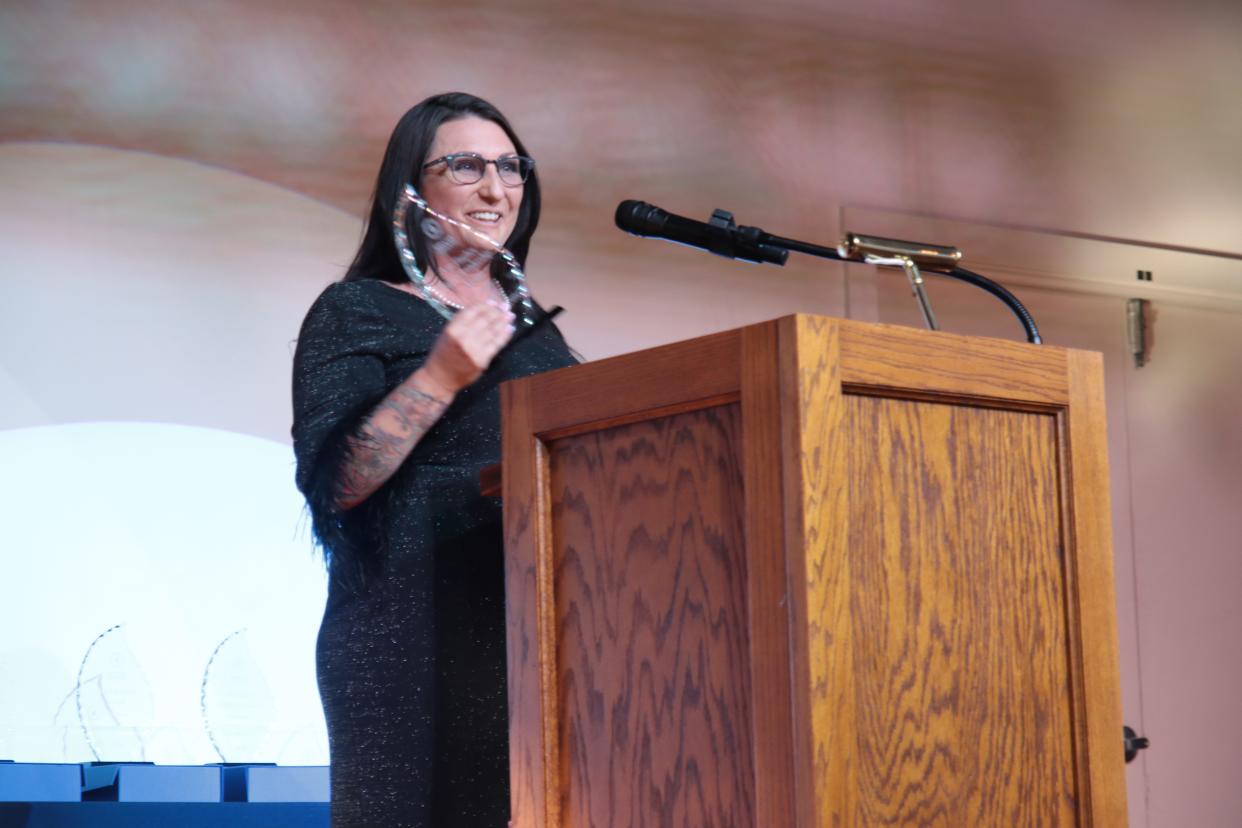 Kandice Karll-Newsome accepts the Ann Hughes Legacy Leadership Award during the Greater Lenawee Chamber of Commerce's awards ceremony May 1 at the Adrian Armory Events Center.