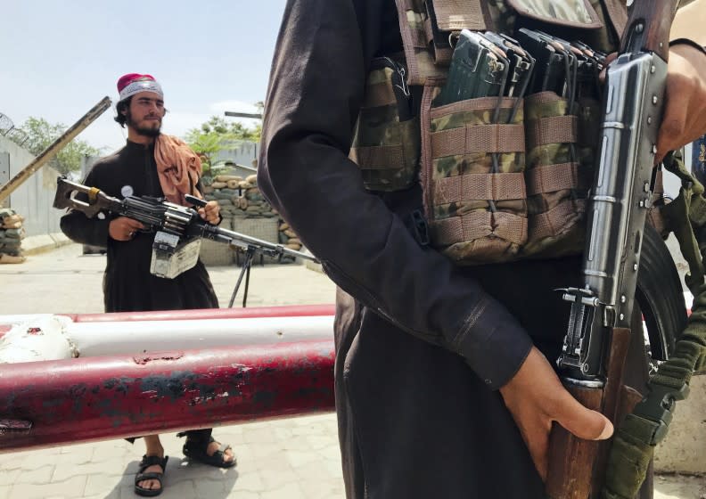 Taliban fighters stand guard at a checkpoint near the US embassy that was previously manned by American troops, in Kabul, Afghanistan, Tuesday, Aug. 17, 2021. The Taliban declared an "amnesty" across Afghanistan and urged women to join their government Tuesday, seeking to convince a wary population that they have changed a day after deadly chaos gripped the main airport as desperate crowds tried to flee the country. (AP Photo)