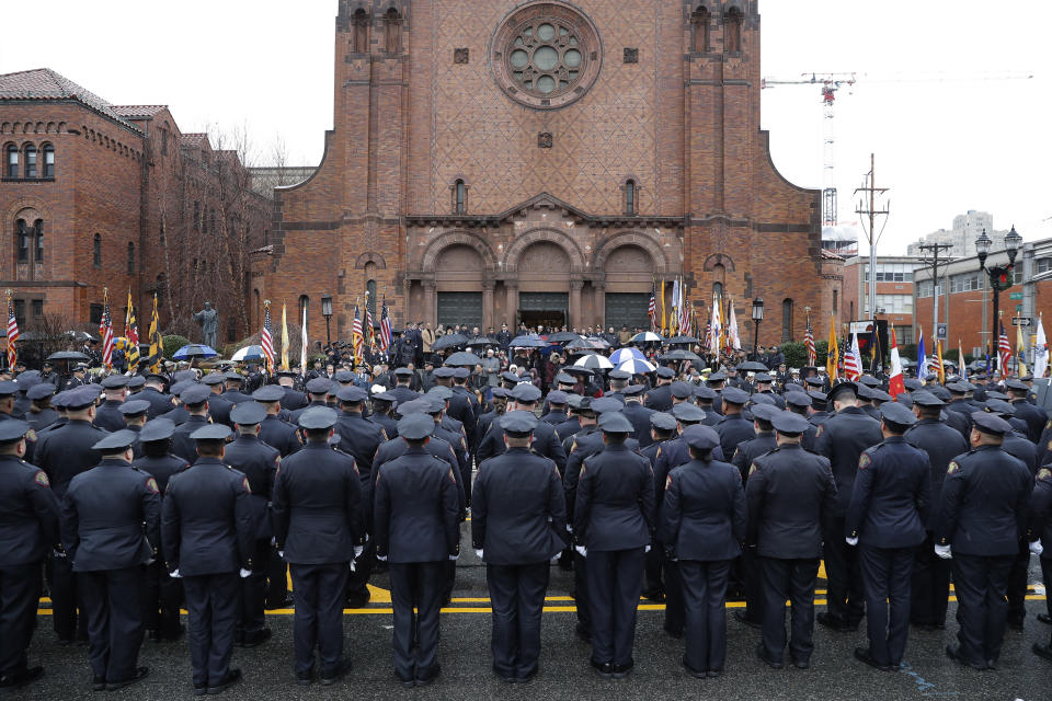 Police officers line up in front of a church during the funeral of Jersey City Police Detective Joseph Seals in Jersey City, N.J., Tuesday, Dec. 17, 2019. The 40-year-old married father of five was killed in a confrontation a week ago with two attackers who then drove to a kosher market and killed three people inside before dying in a lengthy shootout with police. (AP Photo/Seth Wenig)