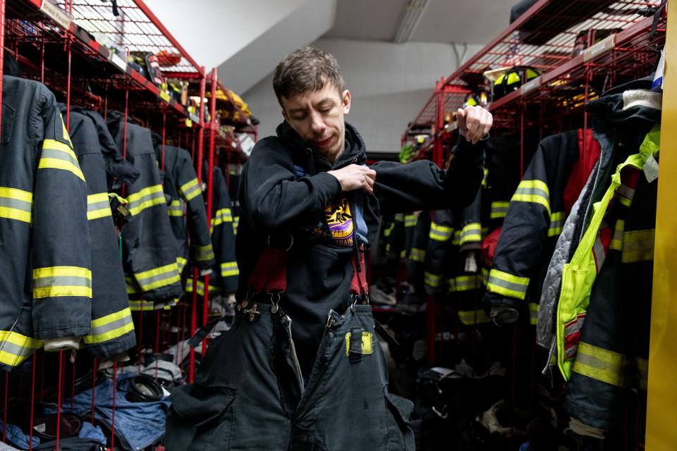 Tobi gets changed for training at the Continental Village Fire Department.