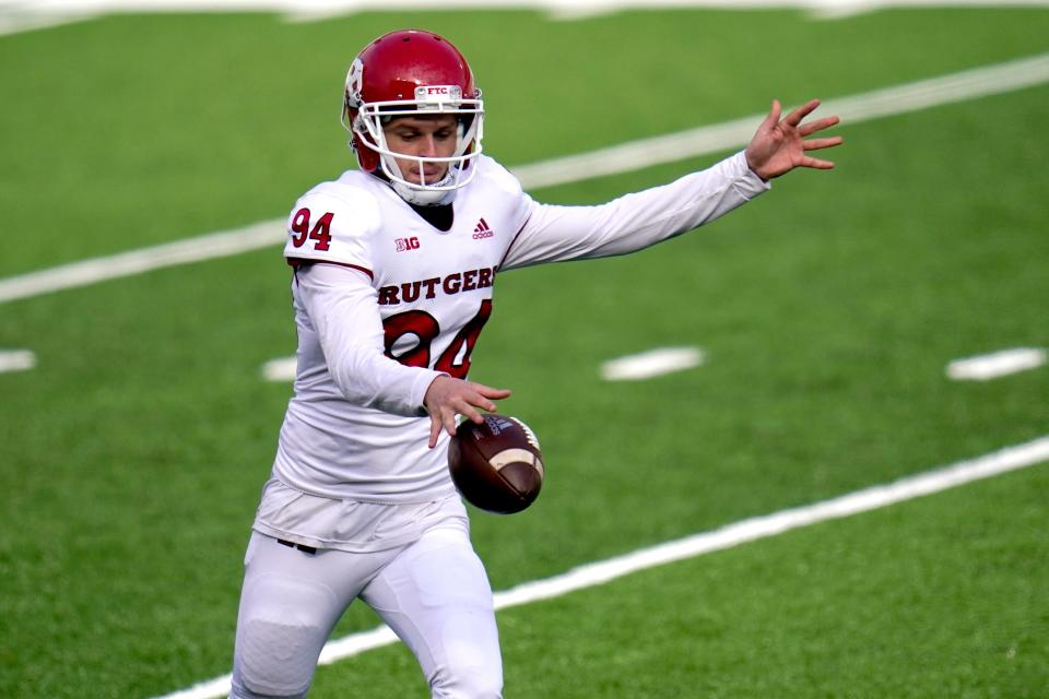 FILE - Rutgers punter Adam Korsak punts to Maryland during the first half of an NCAA college football game in College Park, Md., Saturday, Dec. 12, 2020. (AP Photo/Julio Cortez, File)