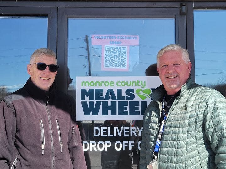 Monroe County Meals on Wheels Volunteer Bill Cullen stands with Commissioner John Christy.