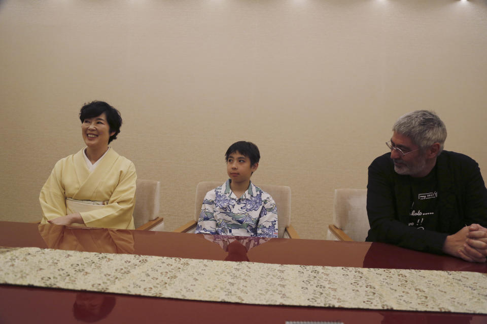 Maholo Onoe, center, with his mother Shinobu Terajima and father Laurent Ghnassia are interviewed at the Kabuki Theater in Tokyo, on May 18, 2023. He is one of the biggest emerging stars in Japan’s 420 year-old Kabuki theater. (AP Photo/Yuri Kageyama)