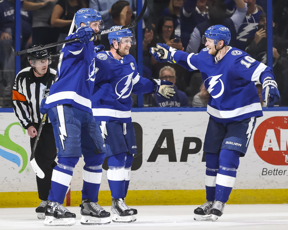 TAMPA, FL - APRIL 21: Steven Stamkos #91 of the Tampa Bay Lightning celebrates a goal and becomes the franchises all-time leader in points with Victor Hedman #77 and Corey Perry #10 against the Toronto Maple Leafs during the second period at Amalie Arena on April 21, 2022 in Tampa, Florida. (Photo by Mark LoMoglio/NHLI via Getty Images)