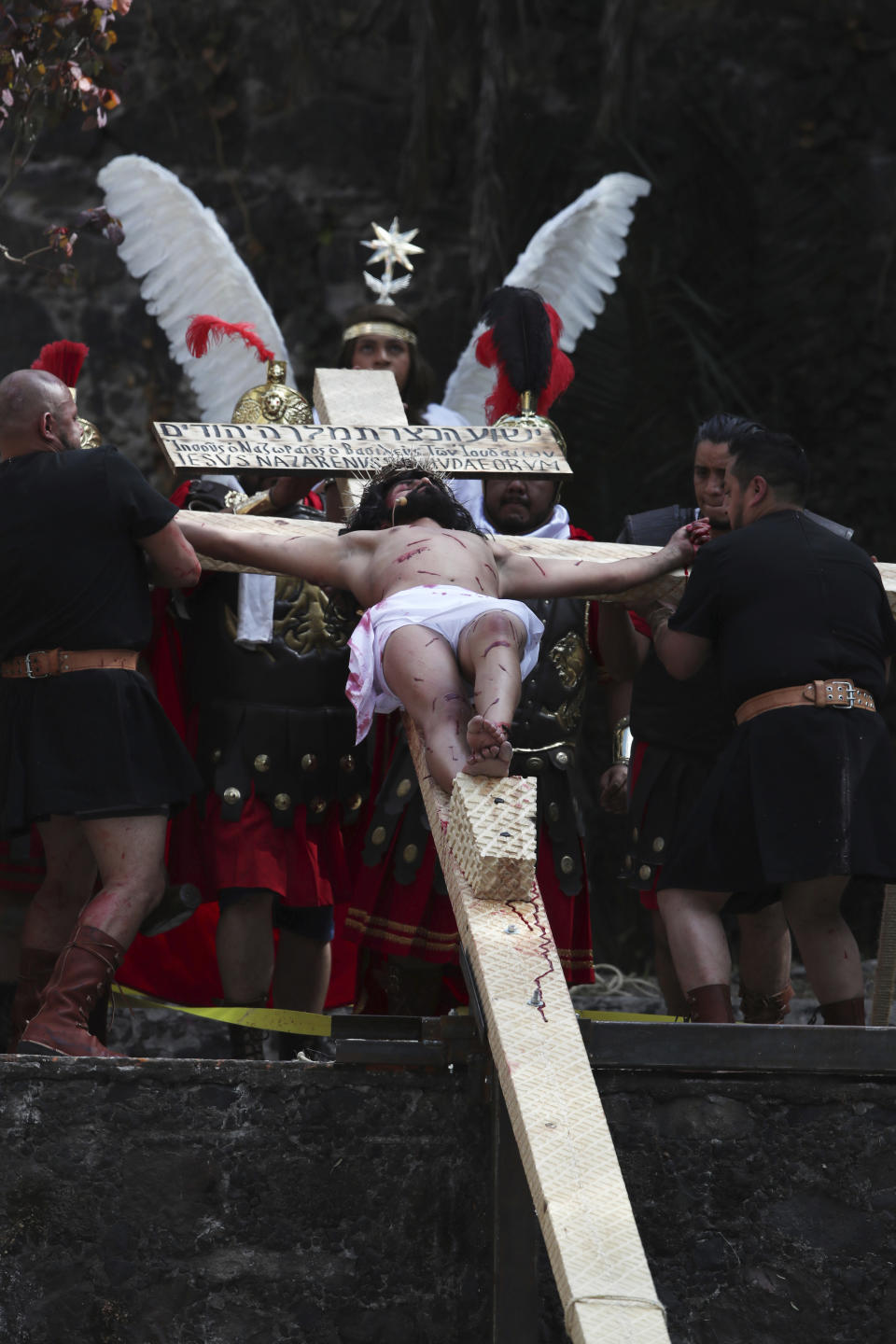 Brando Neri Luna plays the the role of Jesus Christ in the Passion Play of Iztapalapa, outside the Cathedral, on the outskirts of Mexico City, Friday, April 2, 2021, amid the new coronavirus pandemic. To help prevent the spread of the COVID-19, Latin America's most famous re-enactment of the crucifixion of Christ was closed to the public and transmitted live so people could watch at home, for a second consecutive year. (AP Photo/Marco Ugarte)