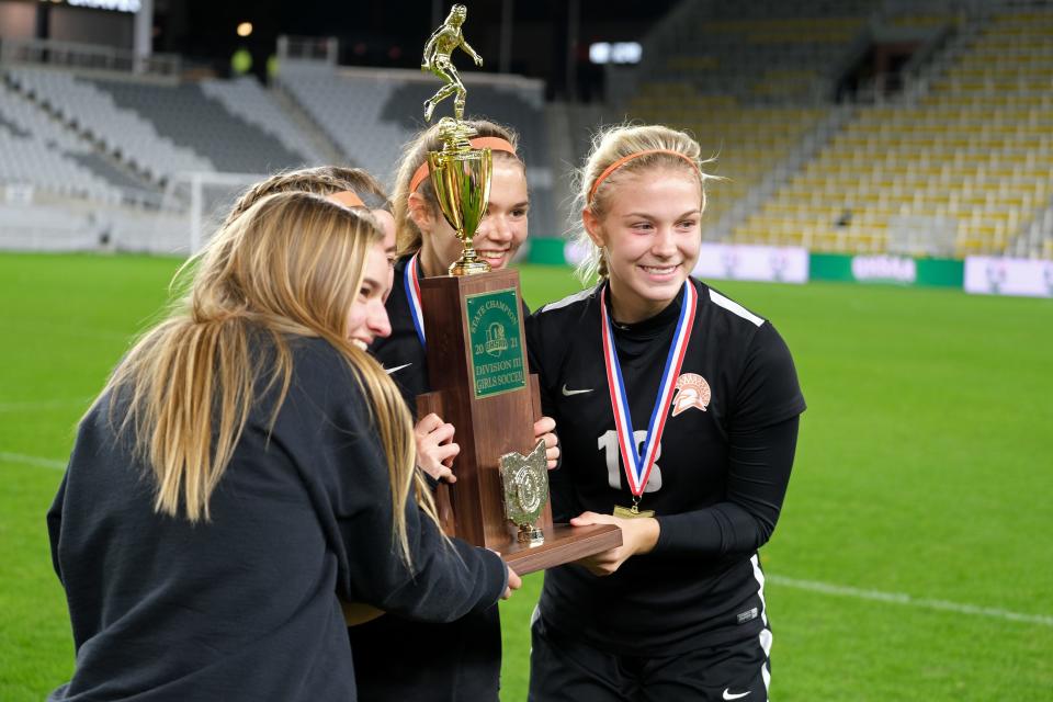 Waynesville is presented with the trophy after winning the OHSAA girls Division III state soccer championship against Ottawa-Glendorf at Lower.com Field in Columbus, Ohio, Friday, Nov. 12, 2021.