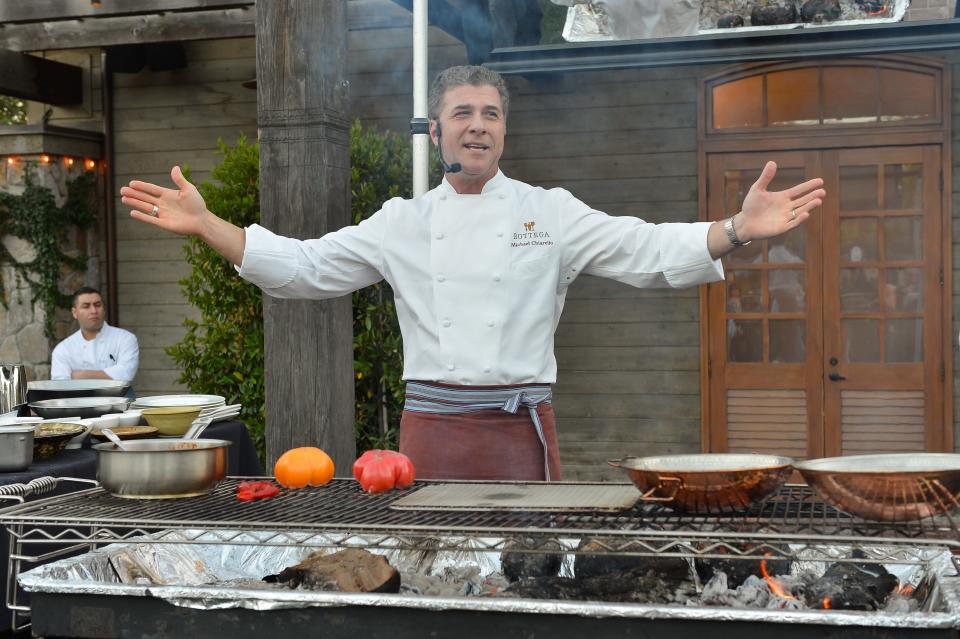 Michael Chiarello cooking behind a grill