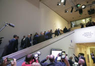 U.S. President Donald Trump waves as he walks up the stairs when arriving at the World Economic Forum in Davos, Switzerland, Wednesday, Jan. 22, 2020. The 50th annual meeting of the forum is taking place in Davos from Jan. 21 until Jan. 24, 2020. (AP Photo/Markus Schreiber)