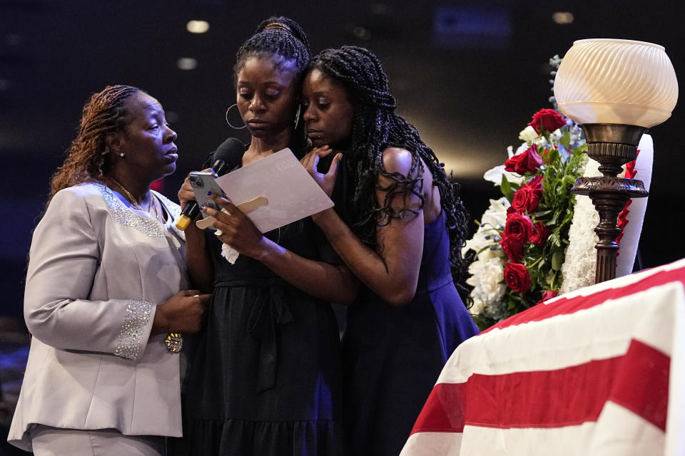 Chantemekki Fortson the mother of slain airman Roger Fortson, left, speaks with family members during the funeral for Fortson at New Birth Missionary Baptist Church, Friday, May 17, 2024, in Stonecrest, Ga. (AP Photo/Brynn Anderson)