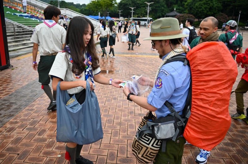 Scouts exchange patches ahead of the K-pop concert on Friday. Photo by Thomas Maresca/UPI