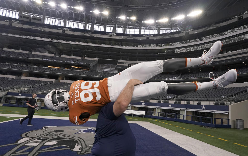 A mannequin wearing a Texas football uniform is carried away after the NCAA college football Big 12 media days in Arlington, Texas, Thursday, July 14, 2022. (AP Photo/LM Otero)