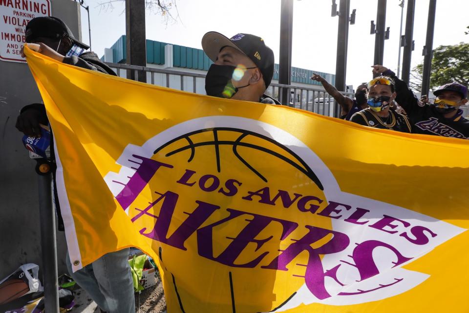 Lakers fan Chris Cielo waves before the start of the Lakers game at the Staples Center on April 15, 2021.