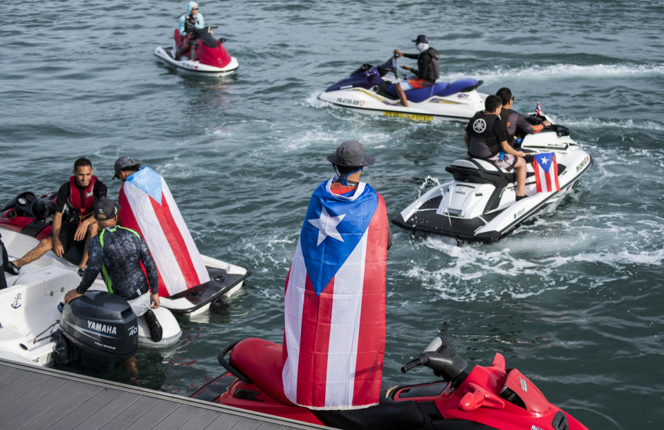 Jet Ski users gathered at San Juan Bay, protesting against Governor Ricardo Rossello, in San Juan, Puerto Rico, Friday, July 19, 2019. Protesters are demanding Rossello step down for his involvement in a private chat in which he used profanities to describe an ex-New York City councilwoman and a federal control board overseeing the island's finance. (AP Photo/ AP Photo/ Dennis M. Rivera Pichardo)