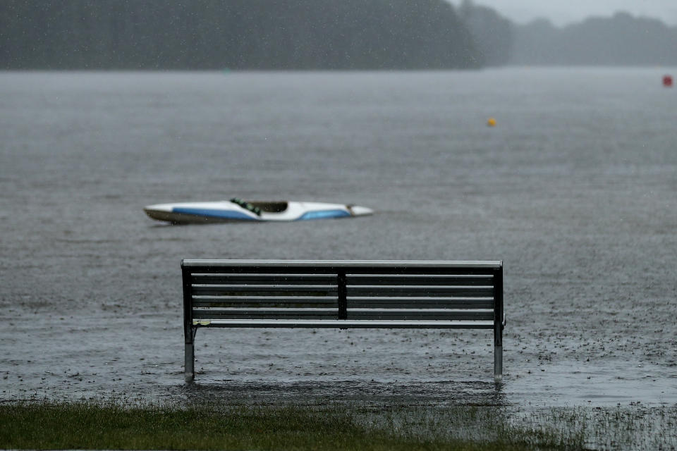 A park bench is flooded at Narrabeen Lake on the Northern Beaches in Sydney on Saturday. Source: AAP