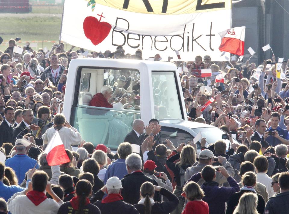 FILE - The popemobile with Pope Benedict XVI drives through the crowd prior to a service in Freiburg, Germany, Sunday, Sept.25, 2011, on his last day of a four-day-visit to his homeland Germany. Pope Benedict XVI leaves his homeland with a complicated legacy: pride in a German pontiff but a church deeply divided over the need for reforms in the wake of a sexual abuse scandal in which his own actions of decades ago were faulted. (AP Photo/Michael Probst, File)