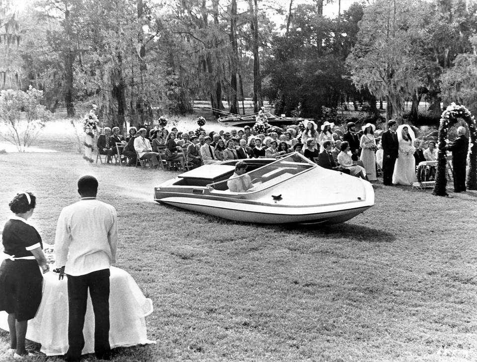 <p>Roger Moore glides out of the water in a motorboat in the Bond film <em>Live and Let Die</em> in 1973.</p>