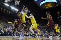 Jan 22, 2019; Ann Arbor, MI, USA; Michigan Wolverines guard Charles Matthews (1) shoots on Minnesota Golden Gophers forward Eric Curry (24) in the first half at Crisler Center. Mandatory Credit: Rick Osentoski-USA TODAY Sports