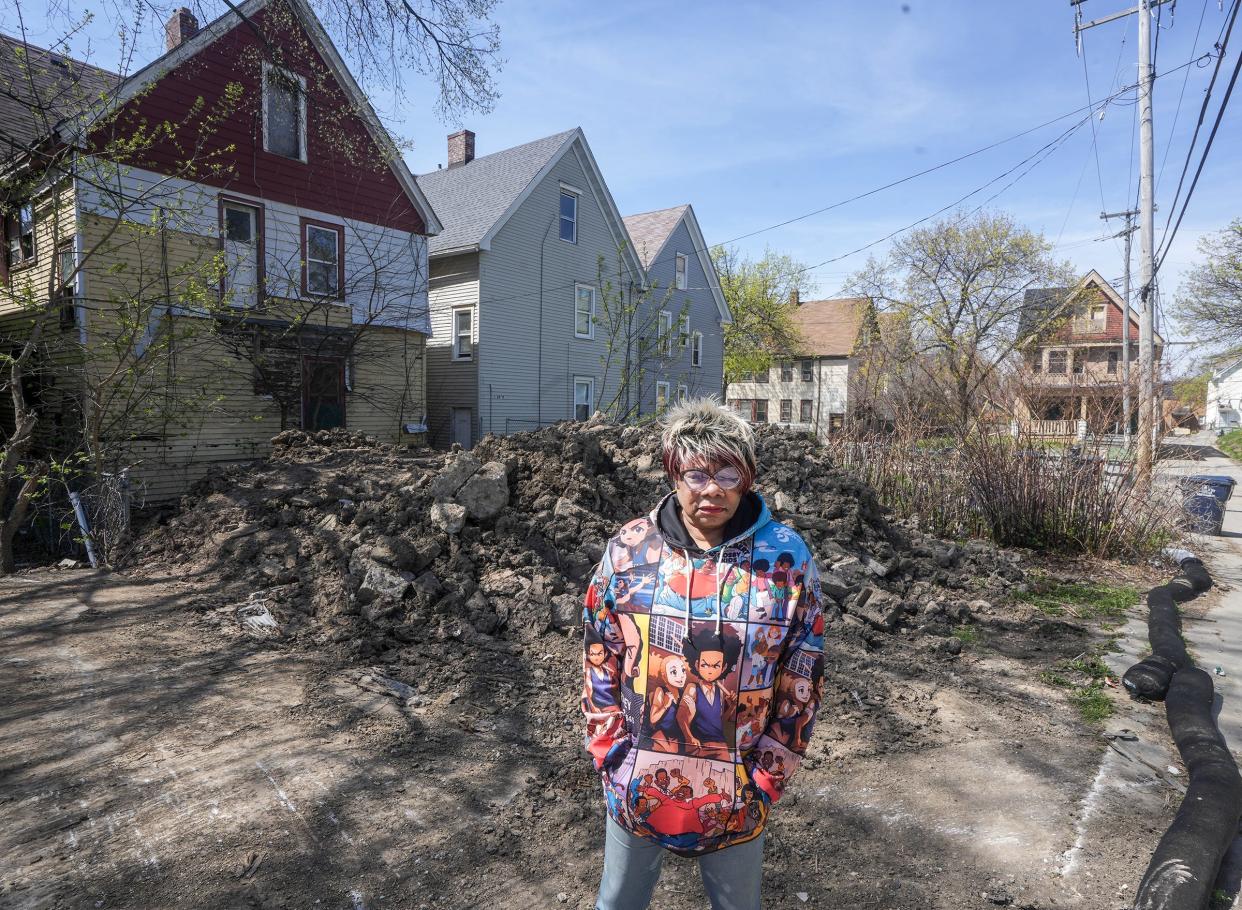 Auriea Mosley, 70, stands in front of her neighbor’s backyard located on West Burleigh Street on April 22.