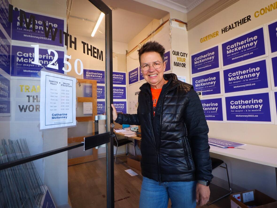 Ottawa mayoral candidate Catherine McKenney stands in the doorway of their Wellington Street West campaign office in late September. McKenney would be the first mayor of a large Canadian city to openly identify as trans non-binary if they win on Oct. 24. (Trevor Pritchard/CBC - image credit)