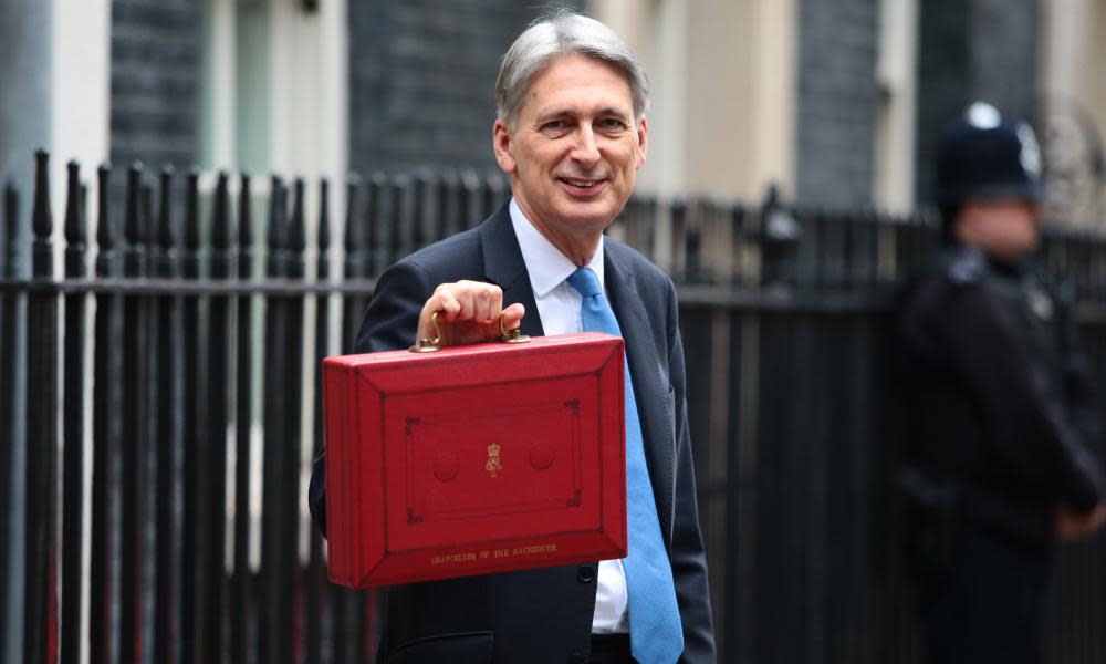 Britain's chancellor of the exchequer, Philip Hammond, holds the red case as he departs 11 Downing Street to deliver his budget to parliament on Wednesday