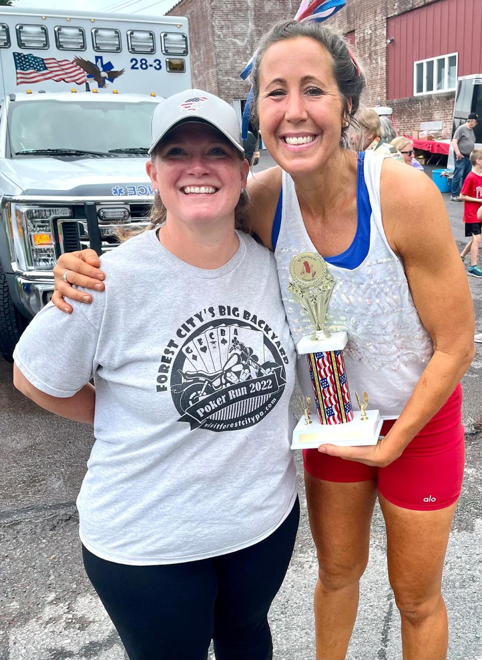 Honesdale's  Tiffany Leventhal (right) accepts the trophy for women's champion at the 2023 Firecracker 5K in Pleasant Mount.