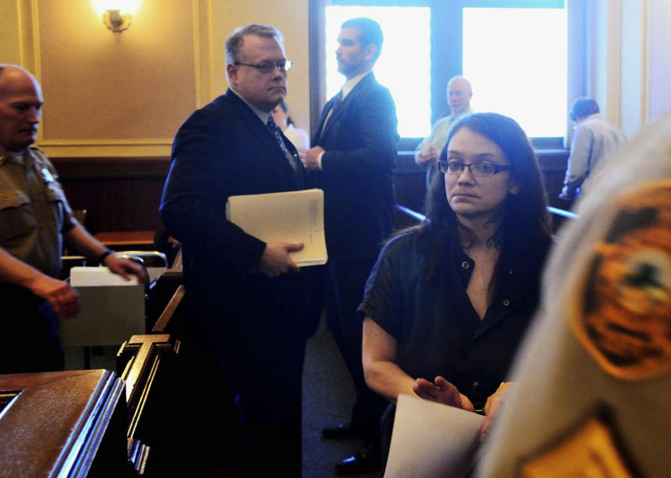 Jessica Jensen, 35, is led out of court followed by her attorney Robert Wade Martin on Thursday, May 1, 2014, in Minot, N.D., after a preliminary hearing where a judge said Jensen will stand trial for murder after her 13-year-old son died weighing just 21 pounds. Jensen's attorney argued that the teenager died of an untreated disease, not deliberate starvation. (AP Photo/The Daily News, Flint McColgan)