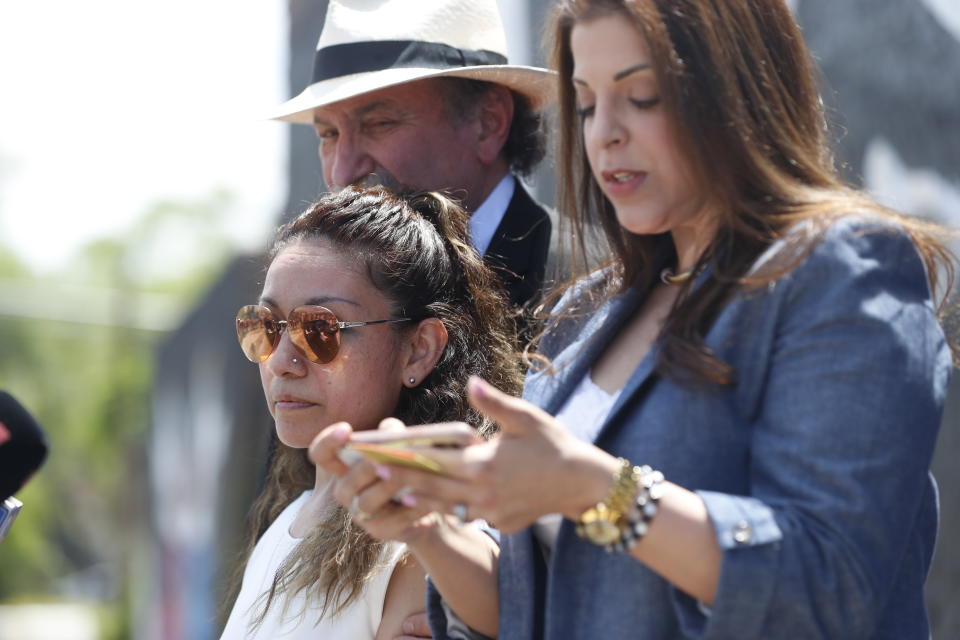 Toledo family attorney Adeena Weiss-Ortiz, right, speaks in behalf of Adam Toledo's mother Elizabeth Toledo, center, during a news conference announcing the opening of Adam's Place Inc., a not-for profit organization aiming to help at-risk youth from Chicago and other Midwestern cities to remain out of trouble, Wednesday, May 26, 2021 in Chicago's West Side. Adam Toledo, 13, was shot and killed March 29 by a Chicago police officer. (AP Photo/Shafkat Anowar)