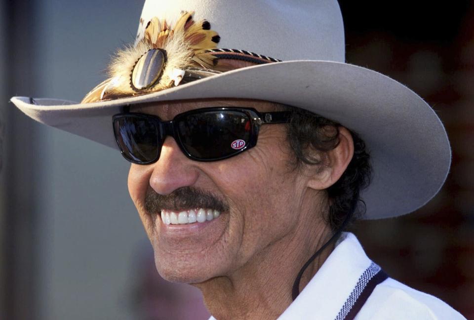 FILE - Seven-time Winston Cup champion Richard Petty, of Level Cross, N.C., smiles as he talks in the garage area at Lowe's Motor Speedway in Concord, N.C., Wednesday, Oct. 6, 1999. (AP Photo/Chuck Burton, File)