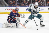 San Jose Sharks' Logan Couture (39) is stopped by Edmonton Oilers goalie Jack Campbell (36) during the third period of an NHL hockey game in Edmonton, Alberta, on Monday March 20, 2023. (Jason Franson/The Canadian Press via AP)