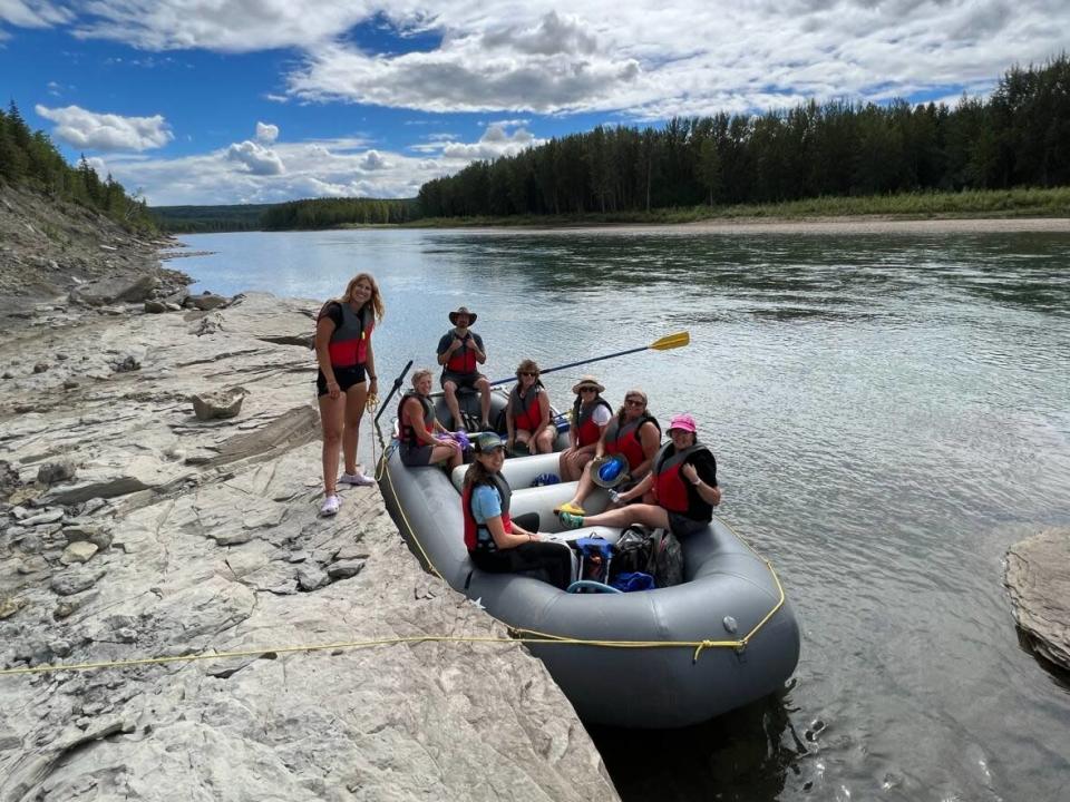 Visitors taking in the 'Secrets of the Wapiti' rafting program offered by the Philip J. Currie Dinosaur Museum near Grande Prairie, Alta. (Submitted by Sydney Allison - image credit)
