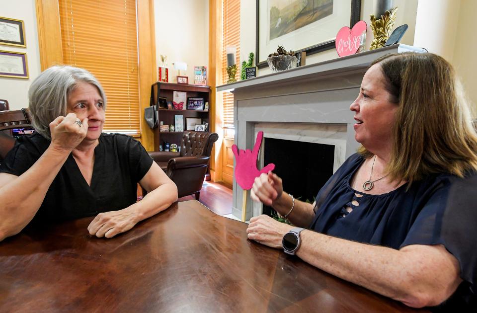 Jenny Savage uses sign language to talk with client Roxy Dawes on April 16 the AIDB offices in Montgomery.