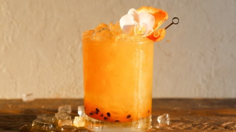 Bright orange cocktail with flower