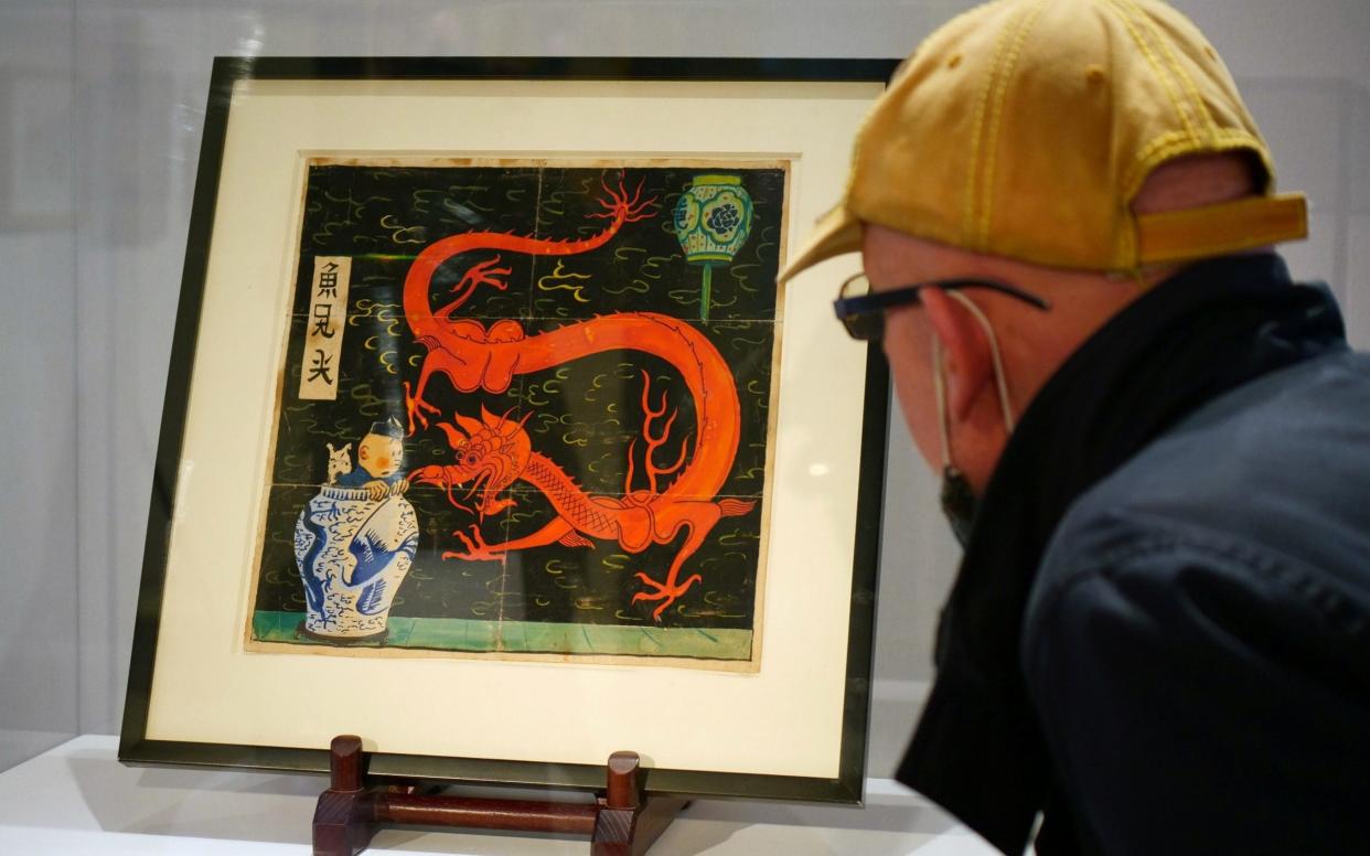 The painting for the original cover of "The Blue Lotus"  Tintin comic book (1936) is displayed before being auctioned by Artcurial in Paris - Noemie Olive/Reuters