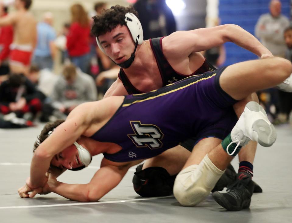 John Jay (CR) Joe Gabriele and Iona's Vinny Tripaldi wrestle in the 131-pound weight class during the Westchester County wrestling championship at Yonkers High School Jan. 20, 2024.