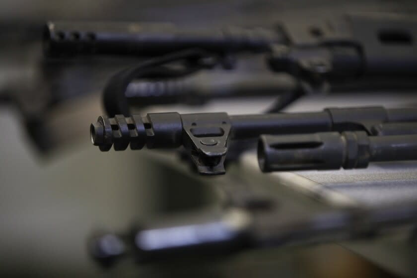 FILE - Illegally possessed firearms seized by authorities are displayed during a news conference Oct. 9, 2018, in Los Angeles. As Americans reel from repeated shootings, law enforcement officials and experts on extremism are taking increasing notice of the sprawling online space devoted to guns and gun rights: gun forums, tactical training videos, websites that sell unregistered gun kits and social media platforms where far-right gun owners swap practical tips with talk of dark plots to take their weapons. (AP Photo/Jae C. Hong, File)