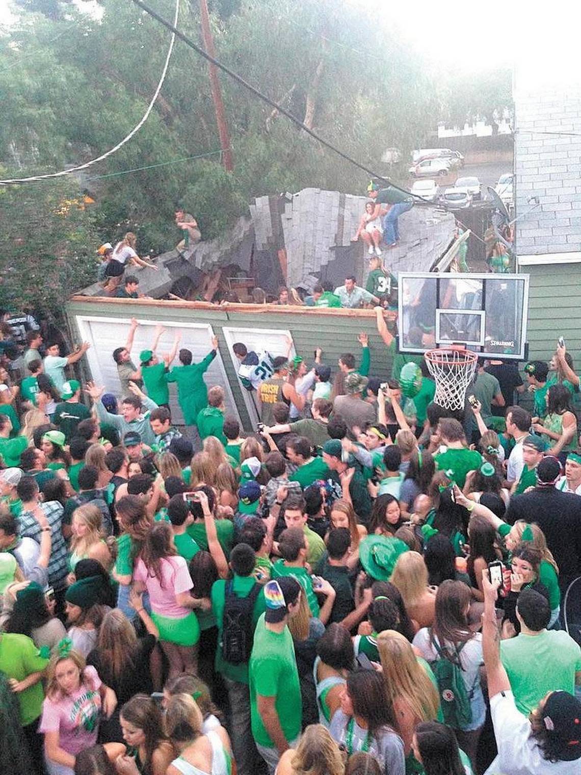 Partiers fall as a garage roof collapses during March 2015 St. Fratty’s Day celebrations at 348 Hathway in San Luis Obispo.