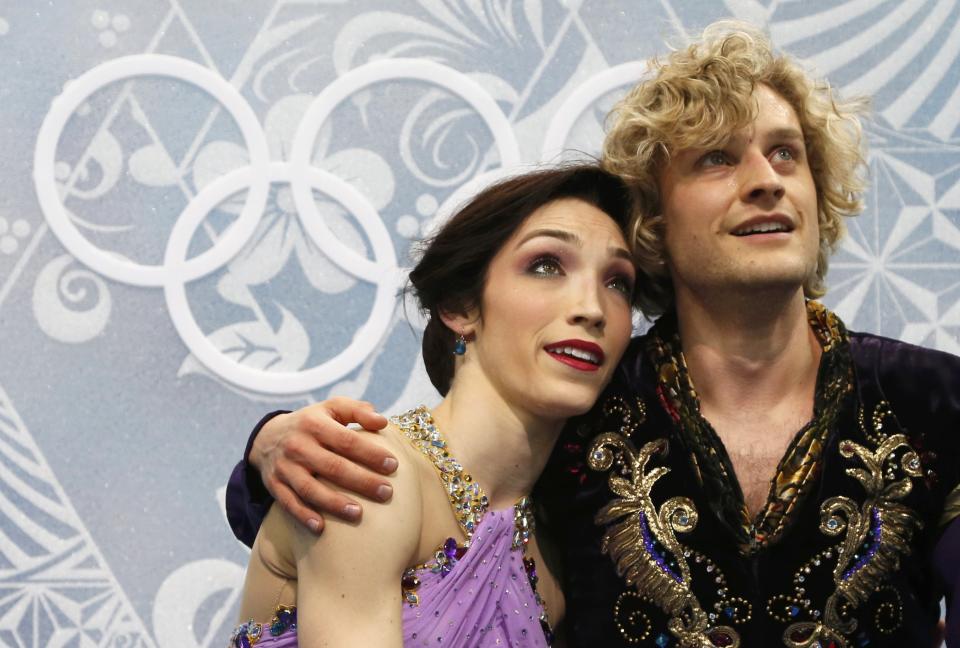 Meryl Davis and Charlie White of the U.S. sit at the "kiss and cry" area after their figure skating ice dance free dance program at the Sochi 2014 Winter Olympics, February 17, 2014. (REUTERS/Lucy Nicholson)