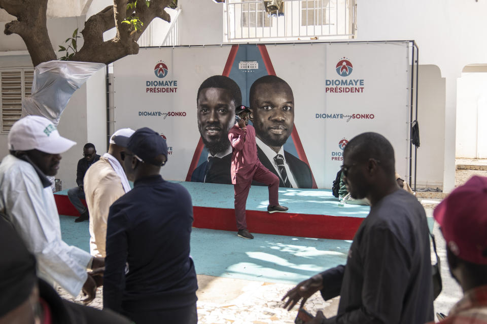 Supporters of Presidential candidate Bassirou Diomaye Faye gather at his campaign headquarters after preliminary results put him as the expected winner, in Dakar, Senegal, Monday, March 25, 2024. Faye's expected victory reflected frustration among youth with high unemployment and concerns about governance in the West African nation. Faye, backed by popular opposition leader Ousmane Sonko, has vowed to protect Senegal from corruption and interference from foreign powers like former colonial master France. (AP Photo/Mosa'ab Elshamy)