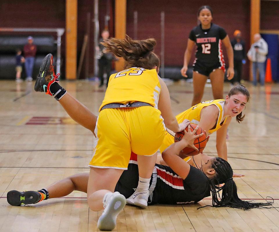 Wildcats Emma Desmond and Megan Doyle try to wrest a loose ball from Boxer Sunali Carter.Weymouth girls basketball hosts the Brockton Boxers on Friday December 9, 2022.