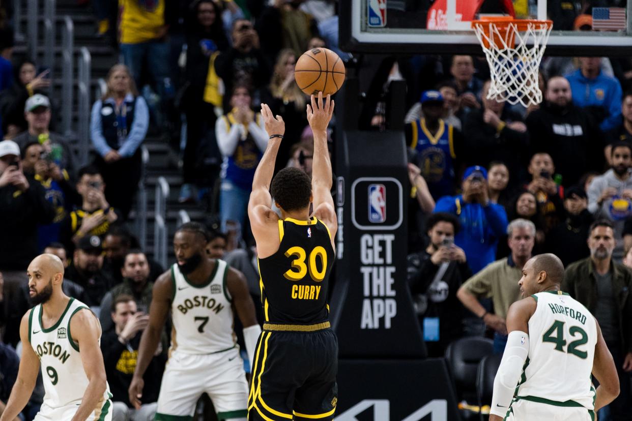 Golden State Warriors guard Steph Curry attempts a three-point shot against the Boston Celtics during their game on Dec. 19, 2023.