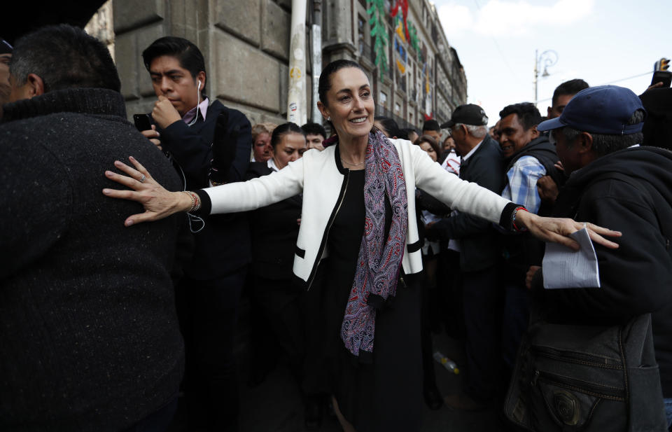 Claudia Sheinbaum, Mexico City's newly sworn in mayor, takes a walk to the Zocalo in Mexico City, on Wednesday, Dec. 5, 2018. Sheinbaum is Mexico City's first elected female mayor. (AP Photo/Eduardo Verdugo)