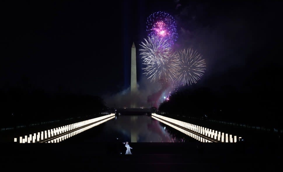 Singer Katy Perry (foreground) performs in front of a firework display during the 