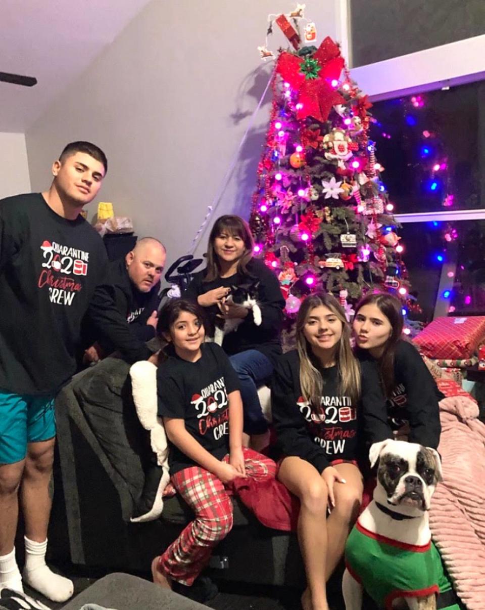 Family photo in front of the holiday tree are (from left) Michael Jr., Mike Sr., Emily, Judith, Sofia and Bella.