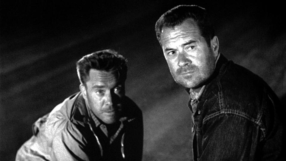 A still from the Hitch-Hiker directed by Ida Lupino shows Edmond O'Brien and Frank Lovejoy looking at the camera in fear