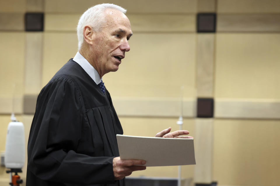 Judge John Murphy hands out certificates of appreciation to and thanks the jury for their service as he dismisses them after they were unable to reach a unanimous decision and a mistrial was declared in the murder trial of Dayonte Resiles at the Broward County Courthouse Wednesday, Dec. 8, 2021, in Fort Lauderdale, Fla. Resiles, 27, remains charged with first-degree murder and manslaughter in the killing of Jill Halliburton Su, during a burglary of her Fort Lauderdale home on Sept. 8, 2014. (Amy Beth Bennett/South Florida Sun-Sentinel via AP)