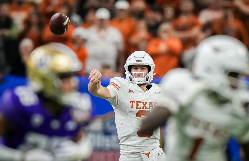 Texas quarterback Quinn Ewers throws downfield during the Longhorns' 37-31 loss to Washington in the Sugar Bowl. Ewers hasn't yet announced his decision as to whether he'll enter the NFL draft or stay in school.