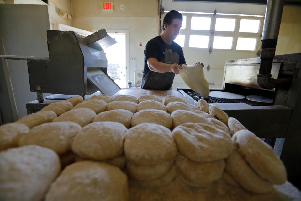 Patrick Mentzer, baker, prepares the homemade pizza crust at a separate facility across the street from Riccardi's Restaurant on Hathaway Road in New Bedford.