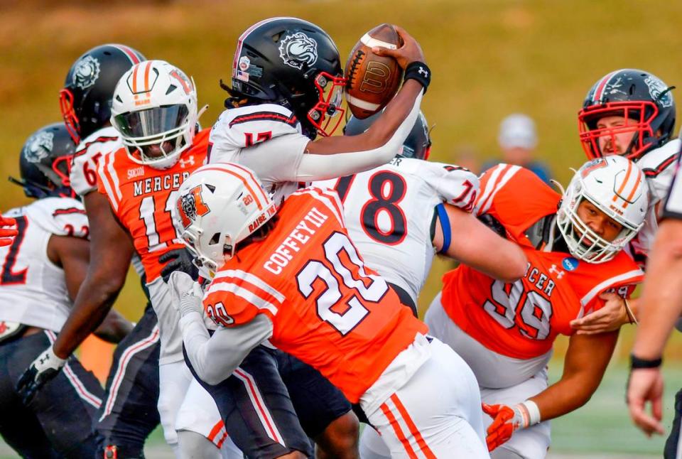 Mercer safety Richie Coffey (20) sacks Gardner-Webb quarterback Jaylen King (17) during their FCS playoff game Saturday in Macon.