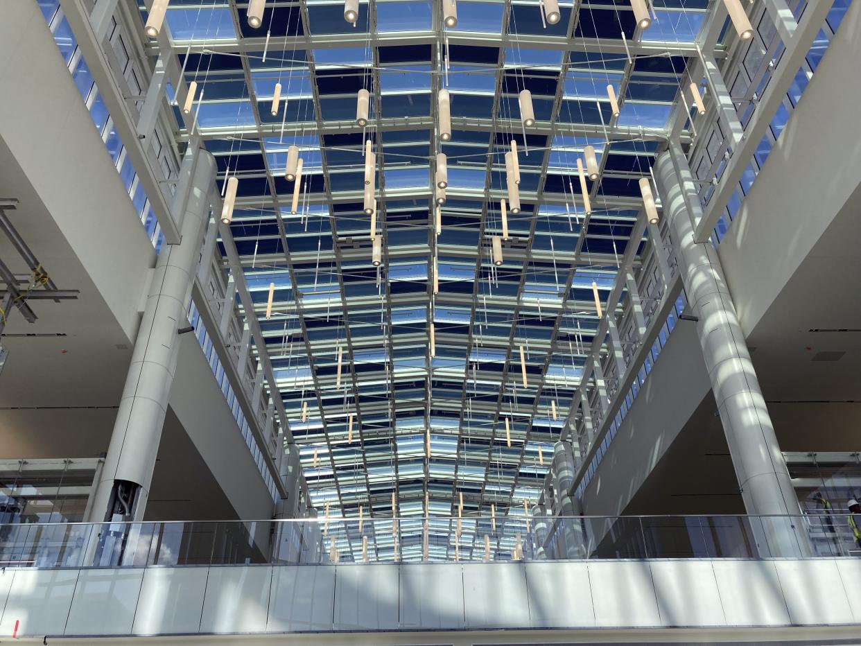 Sun rays beam through the countless windows of its soaring ceilings in the new terminal at Orlando International Airport, Tuesday, Sept. 6, 2022 in Orlando, Fla. With 40.3 million passengers last year, Orlando International Airport was the seventh busiest airport in the world and the busiest in Florida, according to Airports Council International. (AP Photo/Mike Schneider)