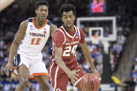 Oklahoma guard Jamal Bieniemy (24) dribbles the ball against Virginia guard De'Andre Hunter (12) during the first half of a second-round game in the NCAA men's college basketball tournament Sunday, March 24, 2019, in Columbia, S.C. (AP Photo/Sean Rayford)